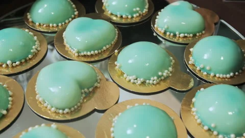Camera moves over the candy bar from macaroons biscuits to turquoise cupcakes Stock Footage 132144683