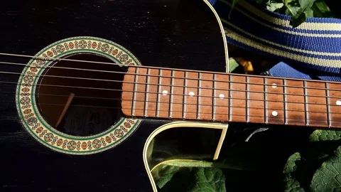 The camera moves over the guitar. Slow Motion. Stock Footage 82727754