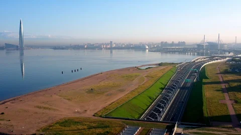 The Camera Moves Over A Modern Highway Against The Skyscraper Stock Footage 115829952
