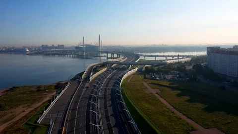 The Camera Moves Over A Modern Highway Against The Skyscraper Stock Footage 115830285