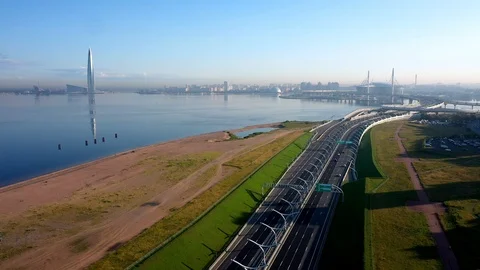 The Camera Moves Over A Modern Highway Against The Skyscraper Stock Footage 115830337