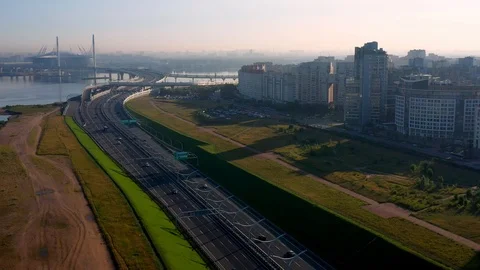 The Camera Moves Over A Modern Highway Against The Skyscraper Stock Footage 115830489