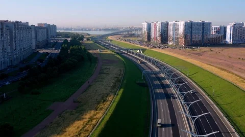 The Camera Moves Over A Modern Highway Against The Skyscraper Stock Footage 117363736