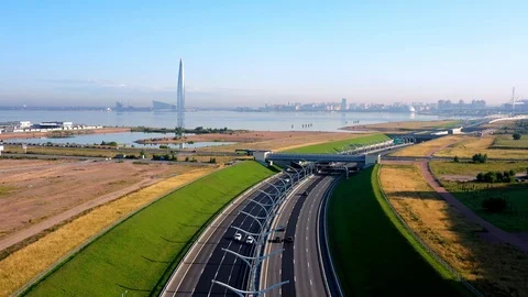 The Camera Moves Over A Modern Highway Against The Skyscraper Stock Footage 117364296