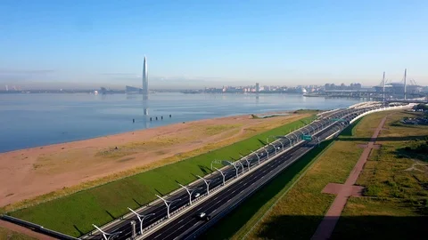 The Camera Moves Over A Modern Highway Against The Skyscraper Stock Footage 117365236