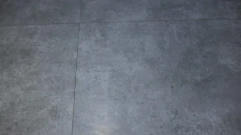 Camera moves over modern technology new smooth polished gray concrete floor Stock Footage 165887052