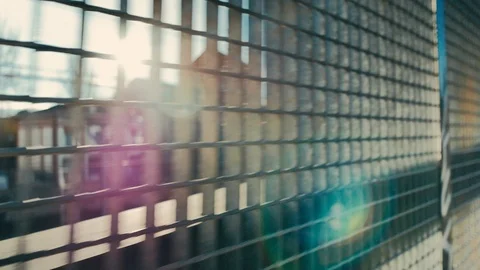 The camera moves parallel to a metal grid, Stock Footage 101727145