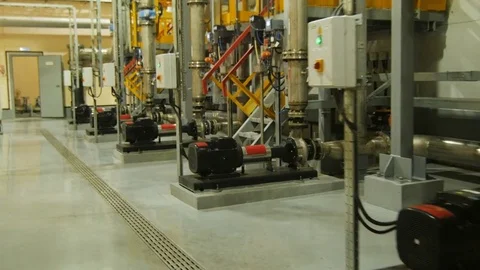 Camera Moves Past Large Pipes and Powerful Engines in Workshop Video stock 81371170