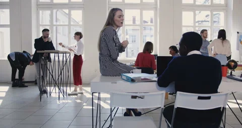Camera moves right along modern light loft office, multiethnic business people Stock Footage 108161195