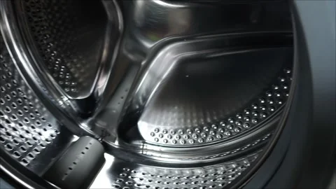 The camera moves from right to left and renders an open washing machine drum. Stock Footage 311992914