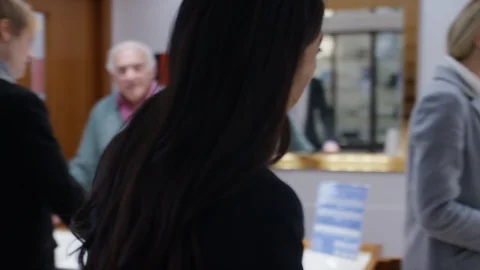 Camera moves with a sales assistant through a jewellery shop Stock Footage 103939262