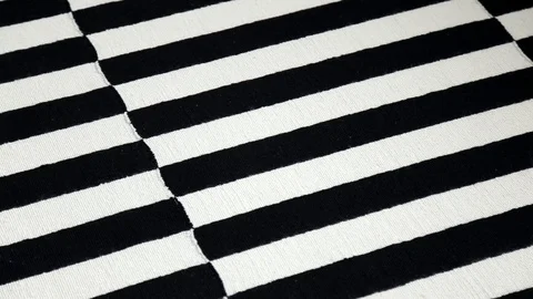 Camera moves slowly along close up texture of black and white fabric. dusty carp Stock Footage 106003655