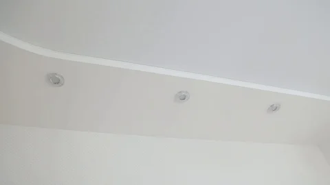 The camera moves slowly along the white ceiling with built-in halogen bulbs Stock Footage 106003920