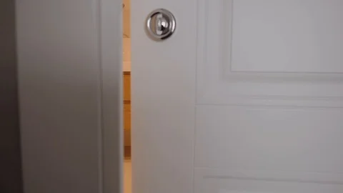 The camera moves slowly forward behind the opening door to the bathroom Video stock 130116238