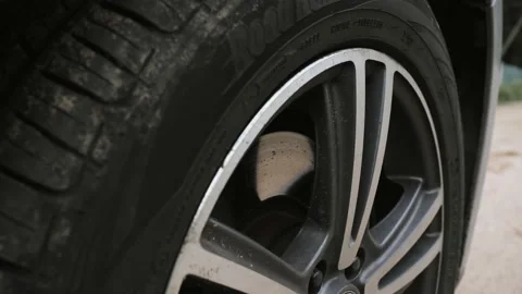 The camera moves slowly from top to bottom along the car wheel. Video stock 139917387