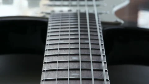 The camera moves smoothly along electric guitar fretboard Stock Footage 144446252