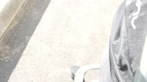 Camera moves from stone pavement to carriage with sleeping baby. Handheld shot Video stock 68991381