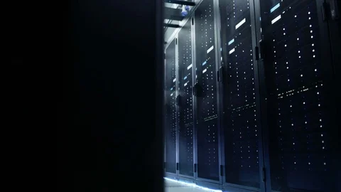 Camera Moves Through Big Working Data Center with Server Racks and Glass Ceiling Stock Footage 74618507