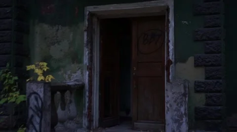 The camera moves through the open door of an abandoned house. Stock Footage 68494306
