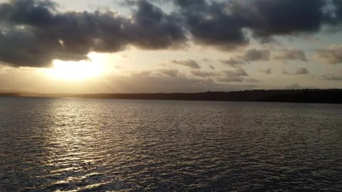 Camera moves through the waters of Lagoa Encantada at sunset in Ilheus Bahi.. Stock Footage 258697467