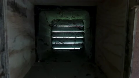 Camera moves into ventilation in a wall there cobwebs move in draft as air Vídeo Stock 147233237