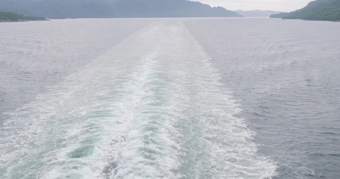 Camera moves up from the watertrace of the ship and goes to a landscape shot 動画素材 96068262