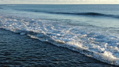 Camera moving along beachline towards breaking wave Stock-Footage 120426772