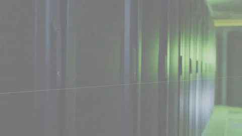 Camera moving along data corridor, cabinets glinting green while animated scans Stock Footage 333061141