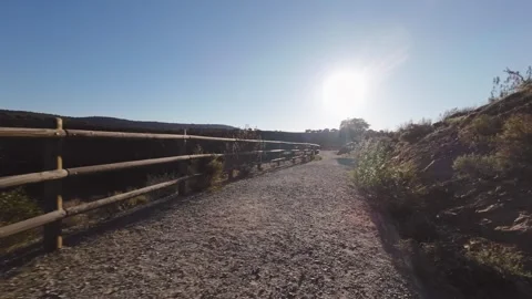 Camera moving along dirt path with wooden fence in Monfrague Extremadura Spa Stock Footage 340553820