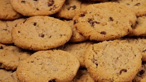 Camera moving along freshly baked oatmeal raisin cookies Video stock 314090378