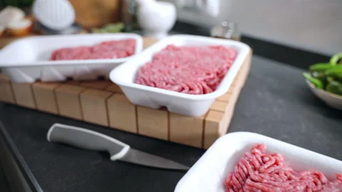 Camera moving along the kitchen work surface with cooking utensils and meat pack Stock Footage 219543847
