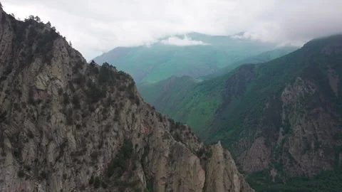 Camera moving along mountain ridge revealing valley town Stock Footage 289642106