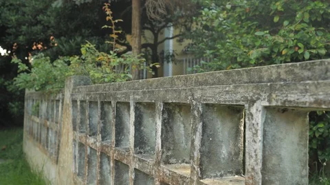 Camera Moving Along the Old Stone Fence in a Yard of Abondaned House in Spain Stock Footage 94593361