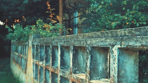 Camera Moving Along the Old Stone Fence in a Yard of Abondaned House in Spain Stock Footage 94593432