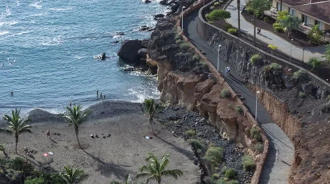 Camera moving along pathway at ocean coast, time lapse. Playa Paraiso, Tenerife Stock-Footage 60440013