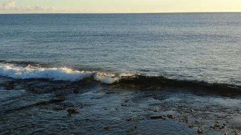 Camera moving along reef edge with small shorebreak waves Stock Footage 120426810