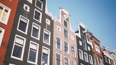 Camera moving along the roofs of Amsterdam old canal houses . Slow motion. Stock Footage 127292684