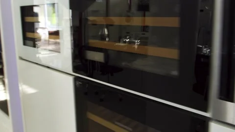 Camera moving along the row of wine coolers and ovens at the domestic appliance Stock Footage 141125377