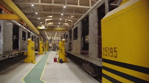 Camera is moving along the train car production workshop. laborers in uniform Stock Footage 202050009