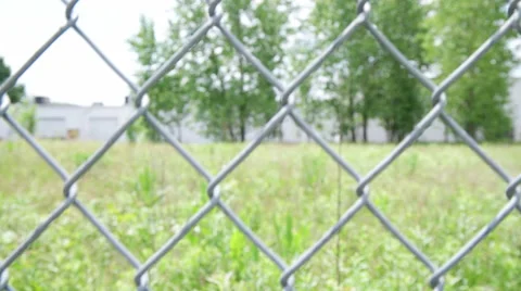 Camera moving up and down behind chain link fence Stock Footage 50767163