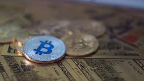 Camera moving around bitcoin coins and golden money dollars and euro on the Stock Footage 104192343