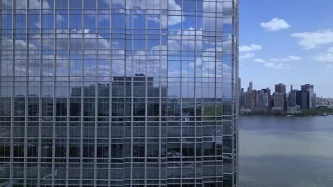 Camera moving around the building to the right and opens a view of New york City 스톡 동영상 240684907