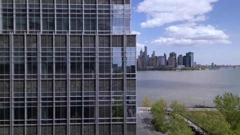 Camera moving around the building to the right and opens a view of New york City Stock Footage 240689066