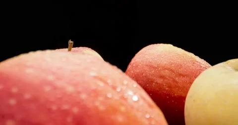 Camera moving around ripe fresh apples in drops of water. Slow motion. Mature Stock Footage 218469455
