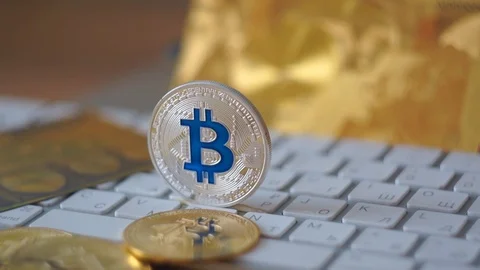 Camera moving around silver bitcoin cymbol on keyboard. Selective focus. Stock Footage 104192708