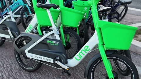 Camera moving back from a close-up of parked rental electric bikes Video stock 336923150