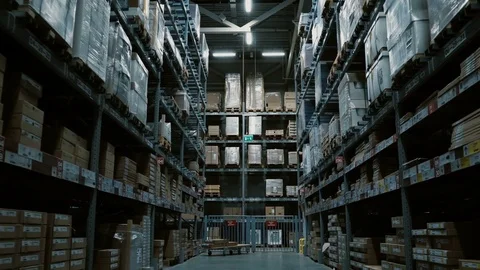 Camera moving backwards through the high shelves with many goods for repair or Stock Footage