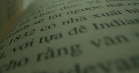 Camera moving between book pages.Fast moving macro view past inside book Stock Footage 220627640