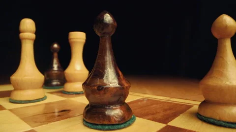 Premium Photo  Closeup of chess pieces on the chessboard under the lights  with a blurry background