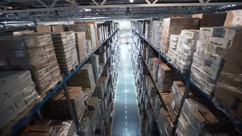 Camera moving between palettes with ordered goods and materials at warehouse 库存影片 74978753